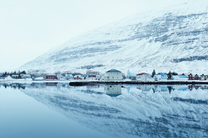 Snowy village by the water