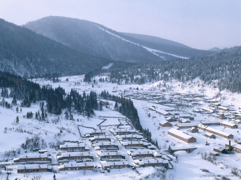Snowy village in mountain valley