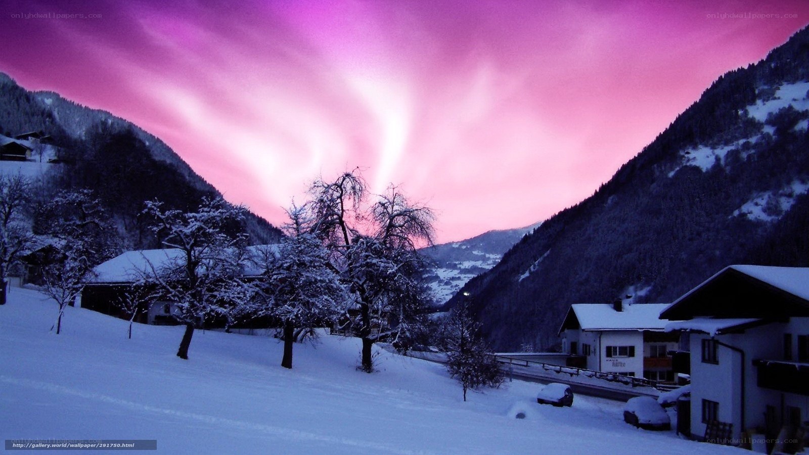 snowy village under pink sky