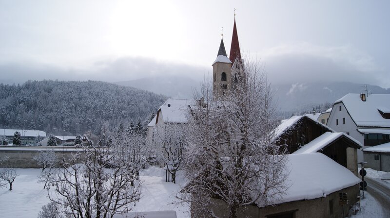 Snowy village with church