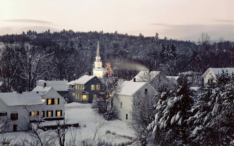 Snowy village with church