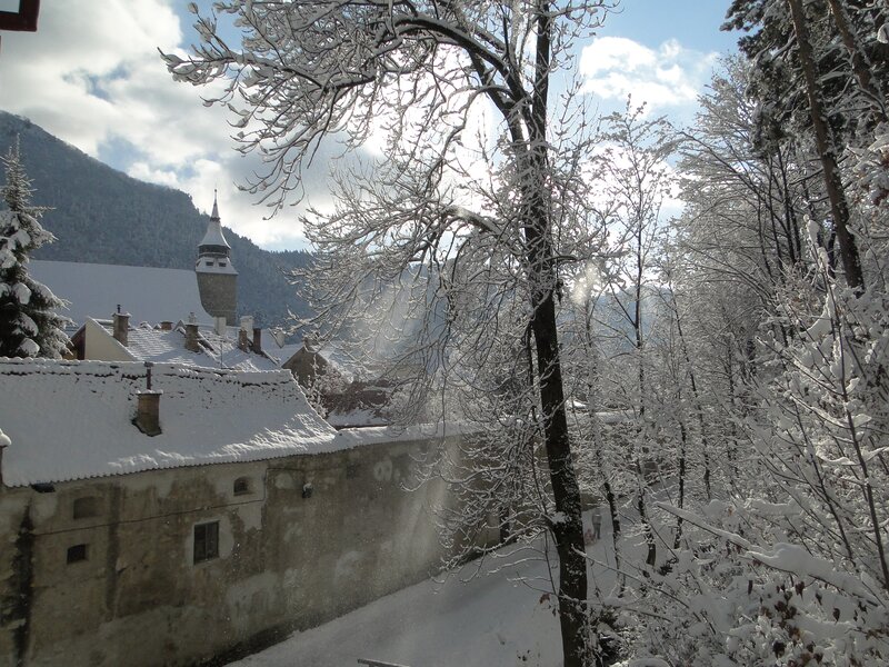 Snowy village with church tower