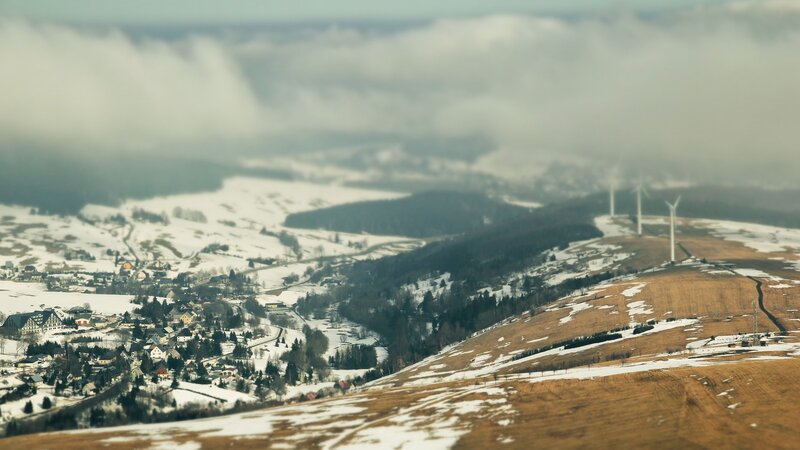 Snowy village with wind turbines