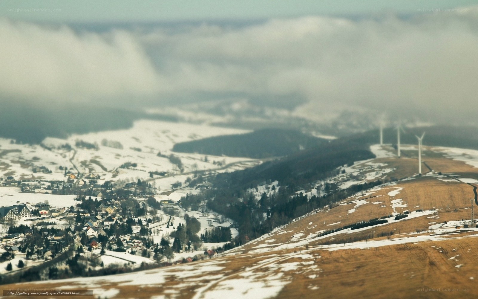 Snowy village with wind turbines