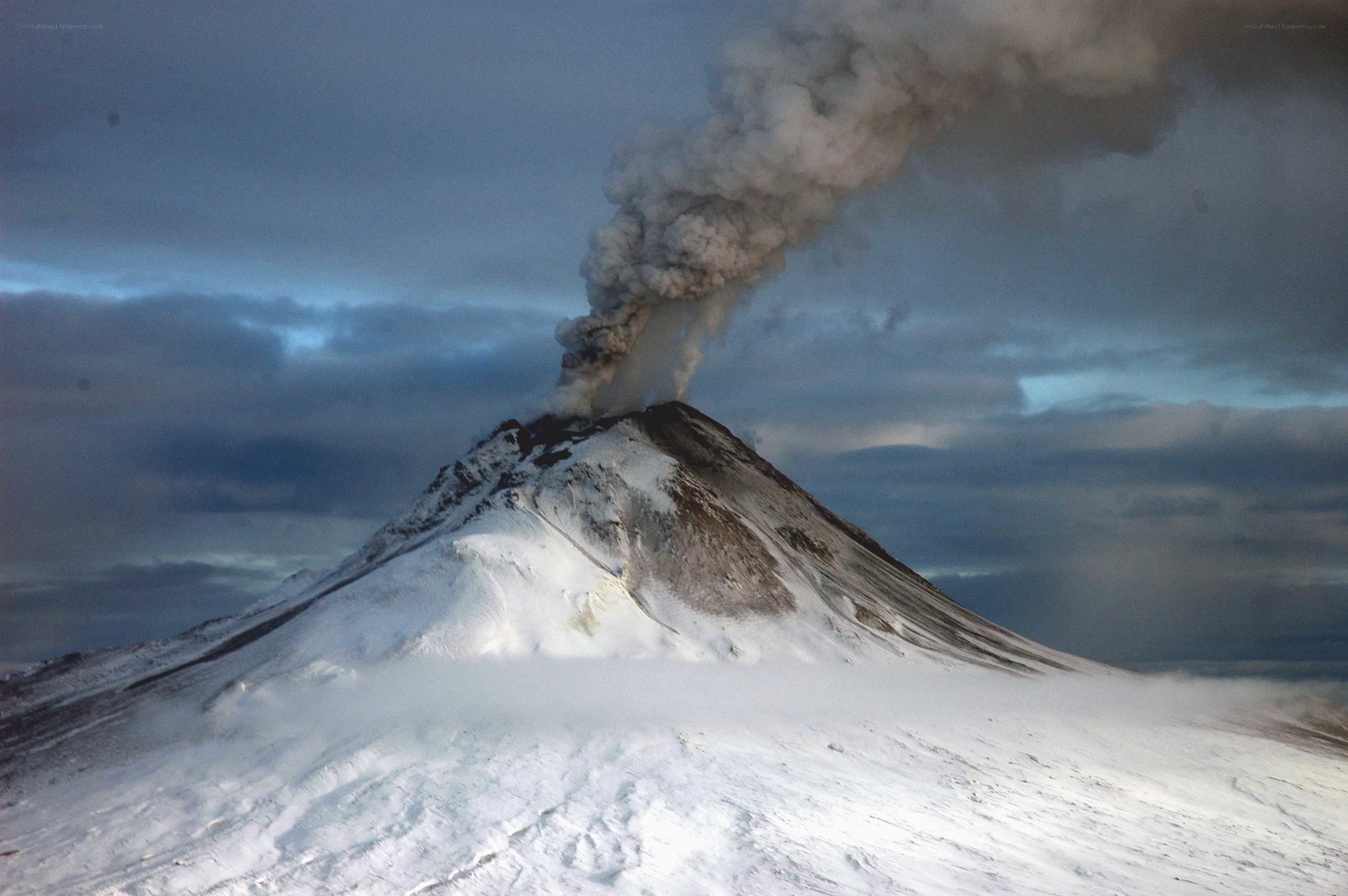 Snowy volcano erupting