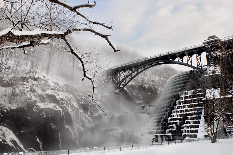Snowy waterfall and bridge