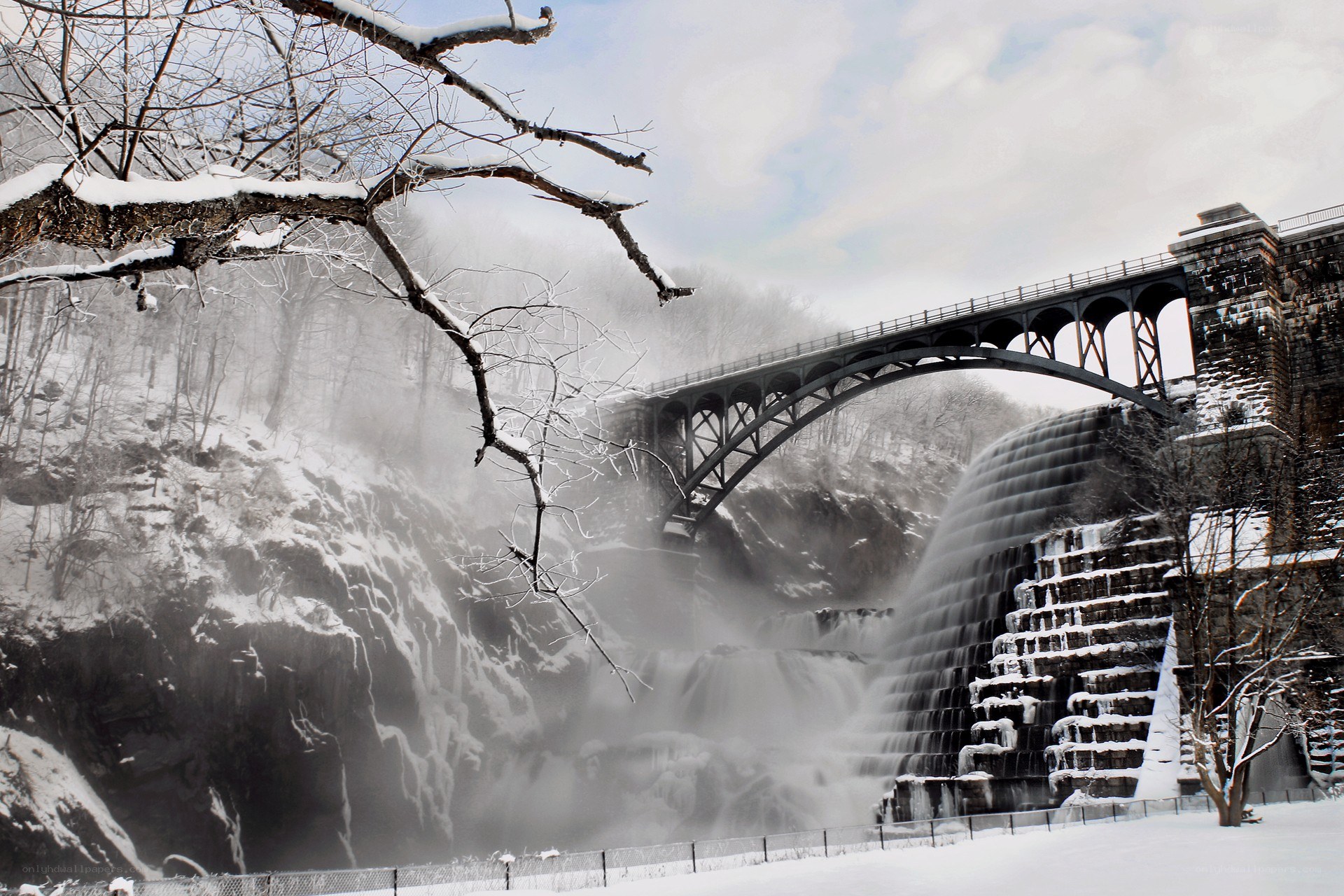 Snowy waterfall and bridge