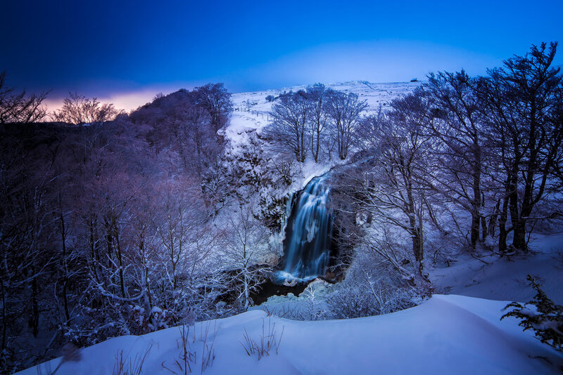 Snowy waterfall at dusk