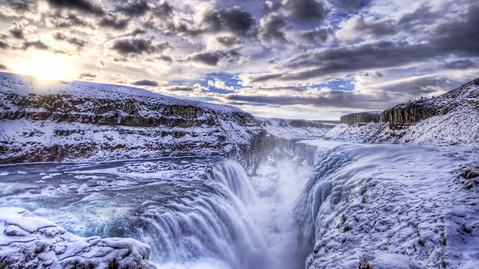 Snowy waterfall at sunset