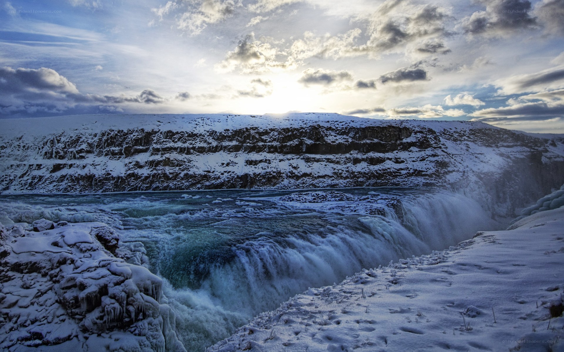 Snowy waterfall at sunset