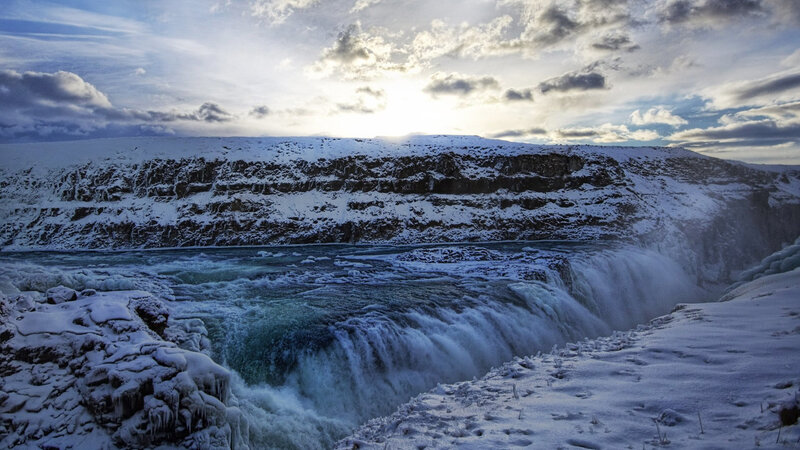 Snowy waterfall at sunset