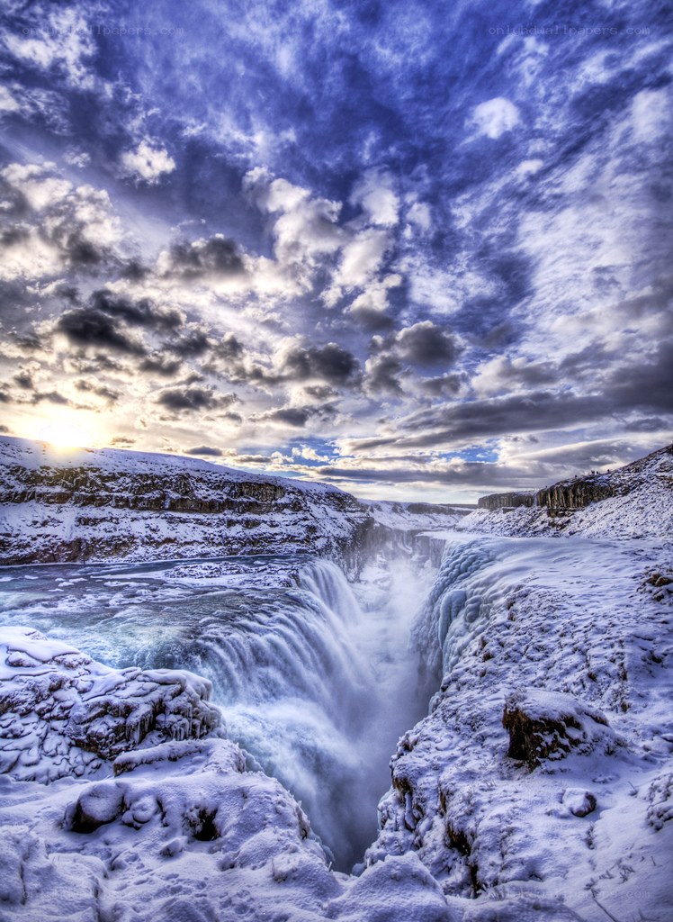 Snowy waterfall at sunset