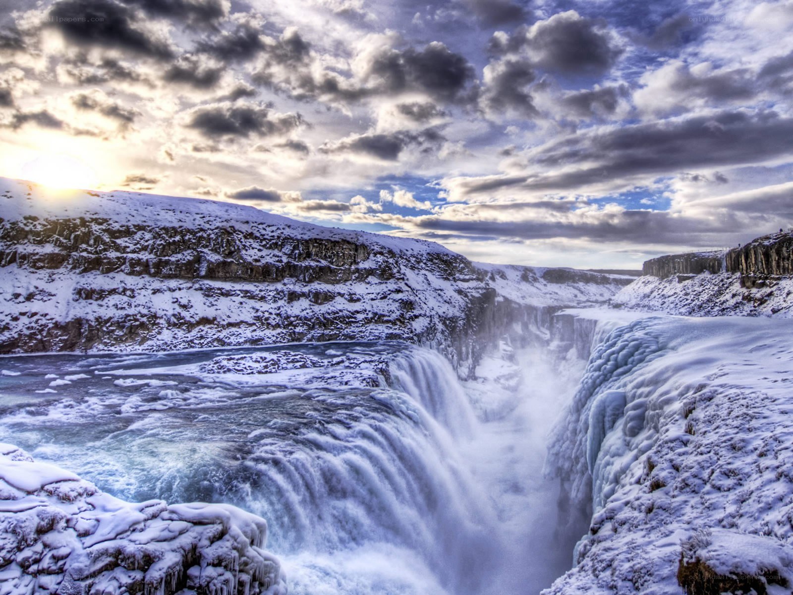 Snowy waterfall at sunset