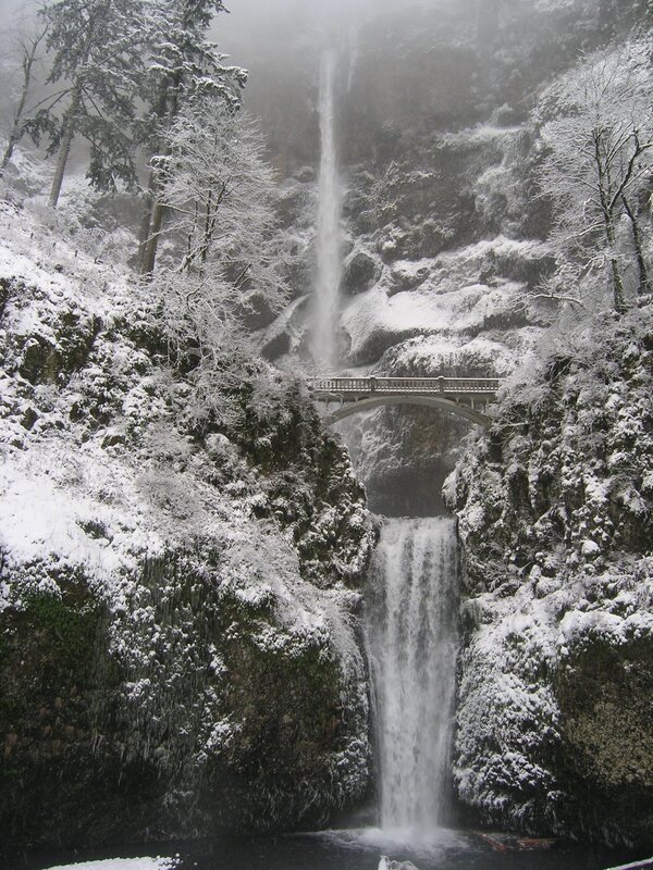 Snowy waterfall with bridge