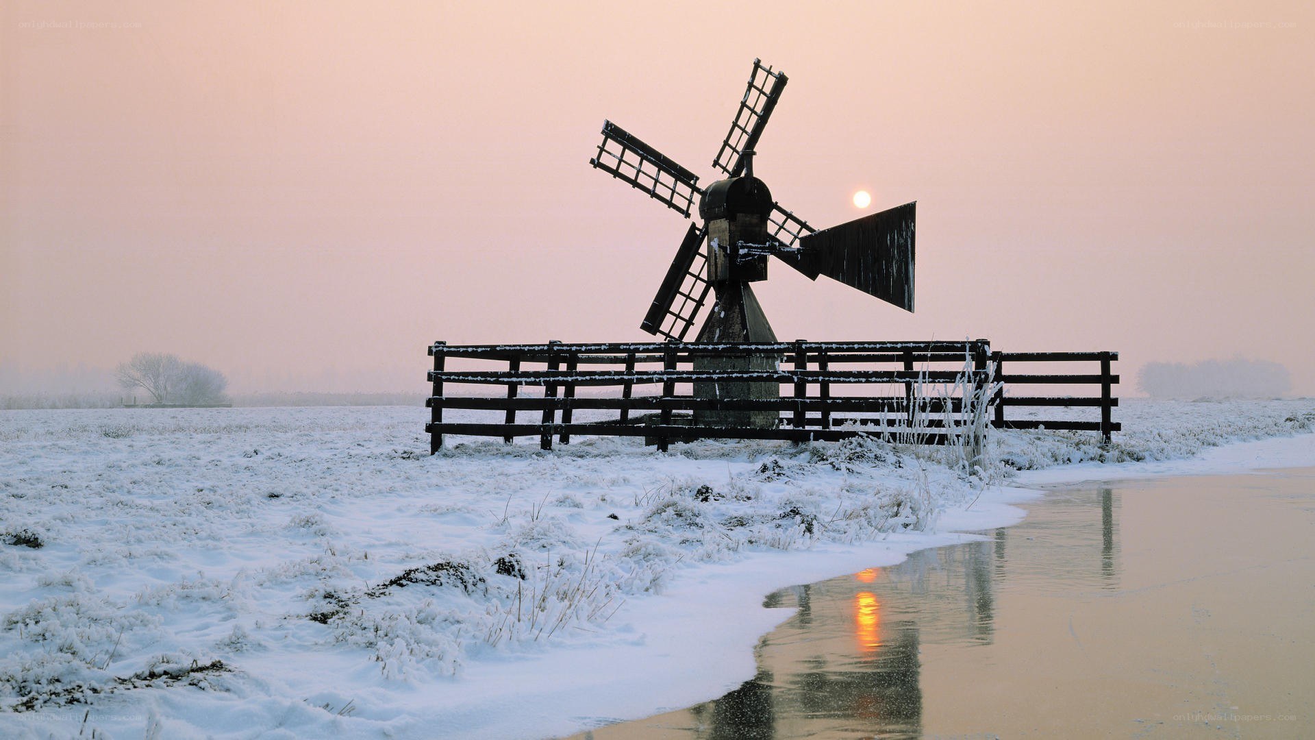 Snowy windmill at sunrise