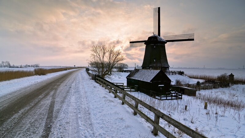 Snowy windmill at sunset