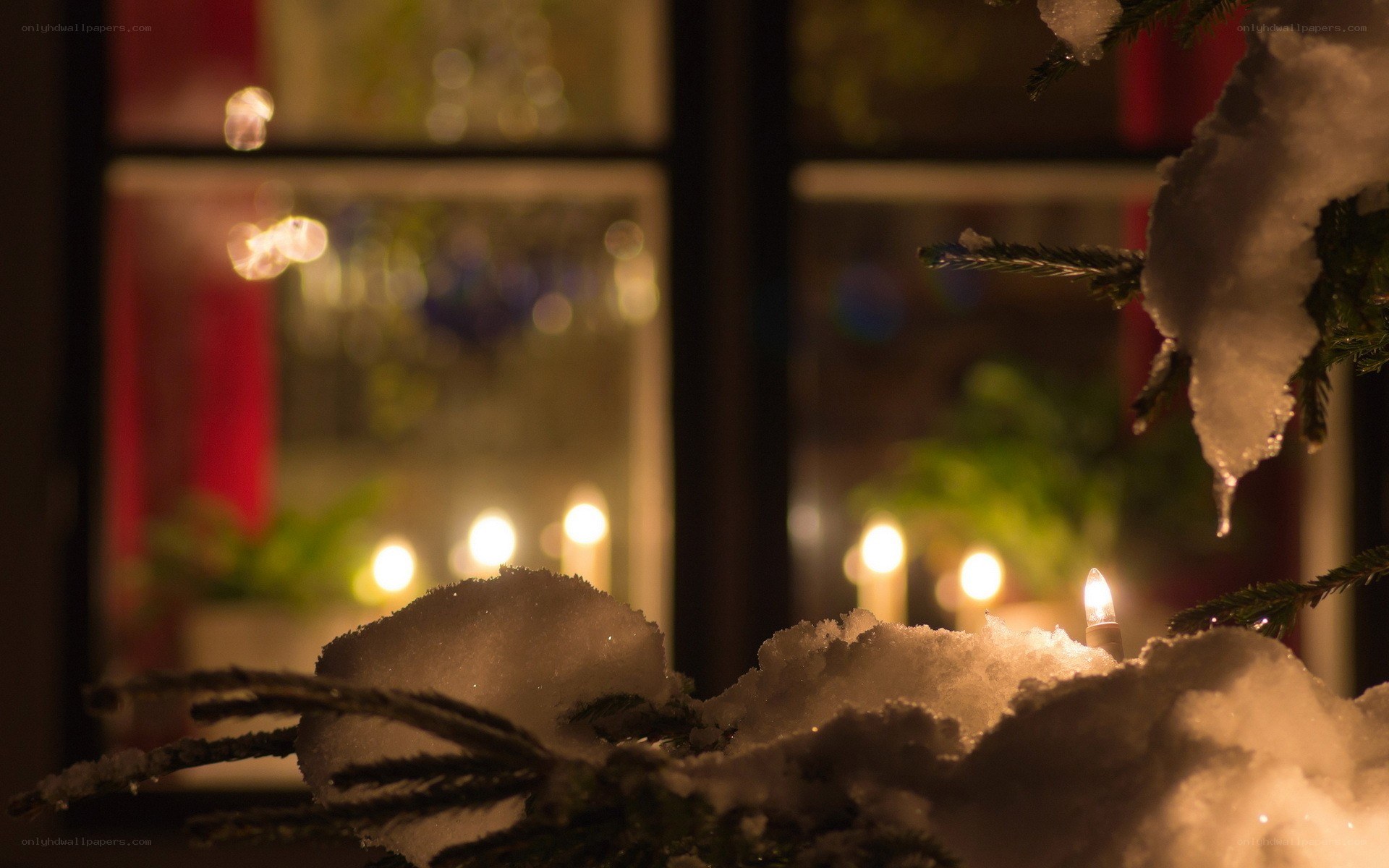 Snowy window with candles