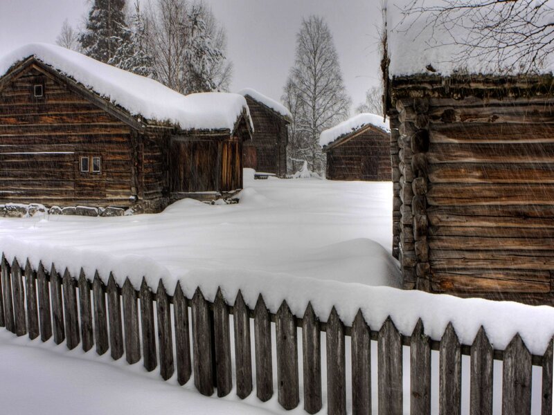 Snowy wooden cabins in winter