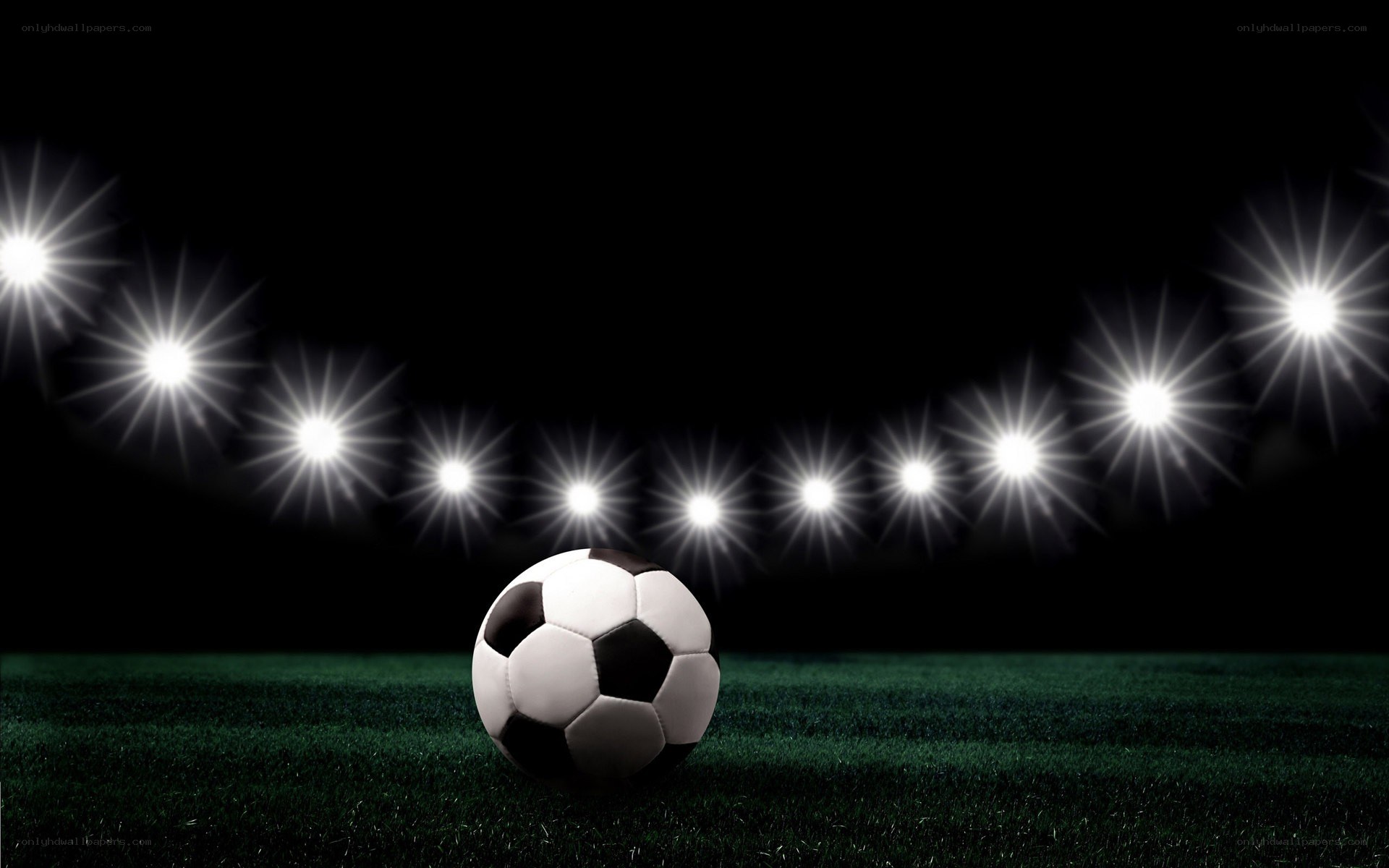 Soccer ball on field under lights