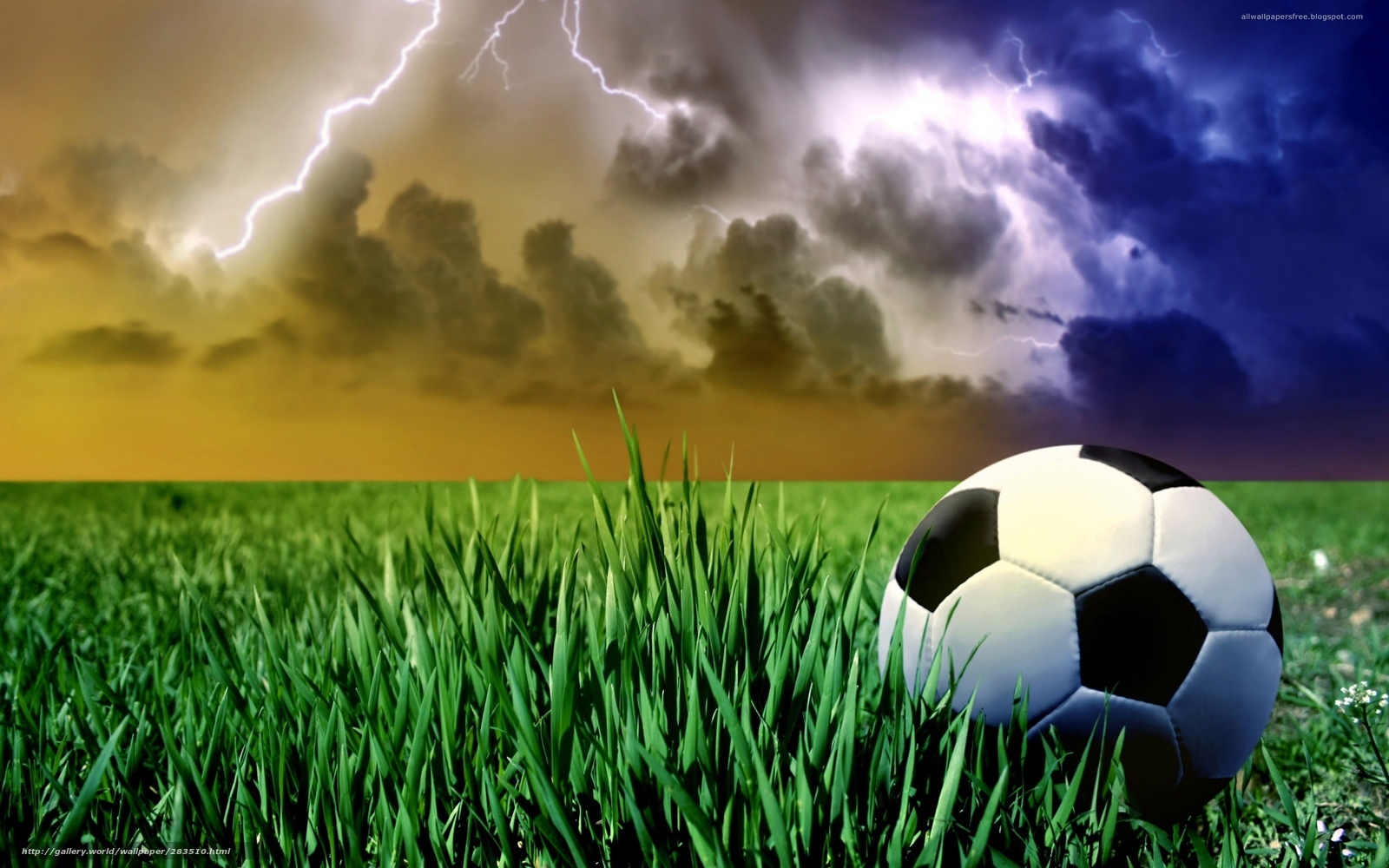 Soccer ball on grass under storm