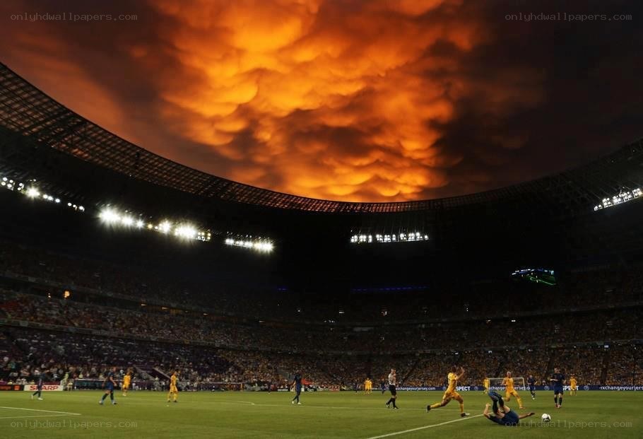 Soccer match under dramatic sky