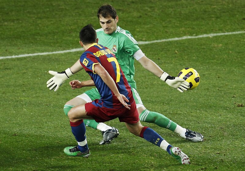 Soccer player and goalkeeper in action