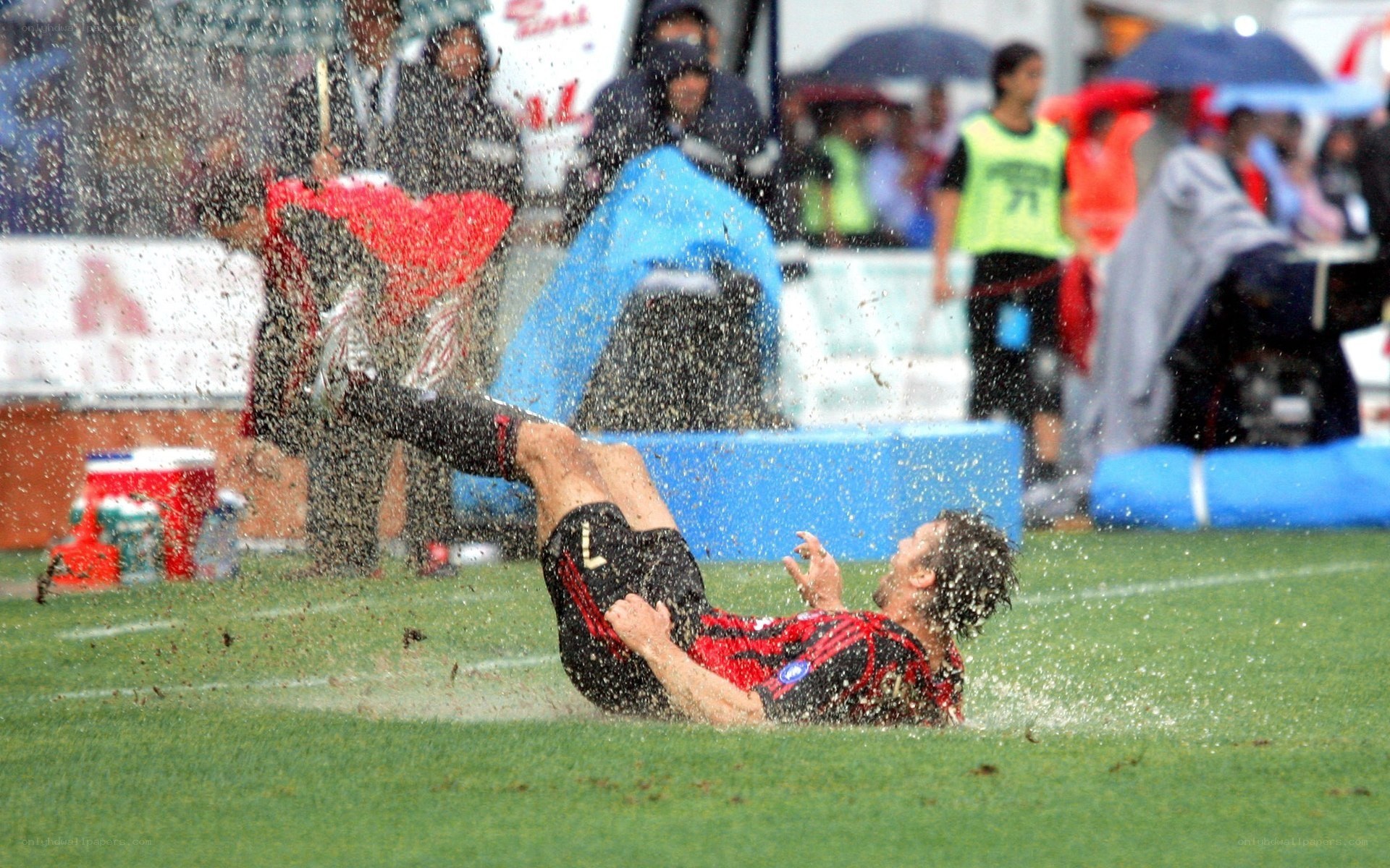 Soccer player falls in rain