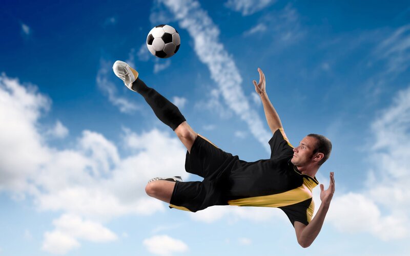 soccer player kicking ball