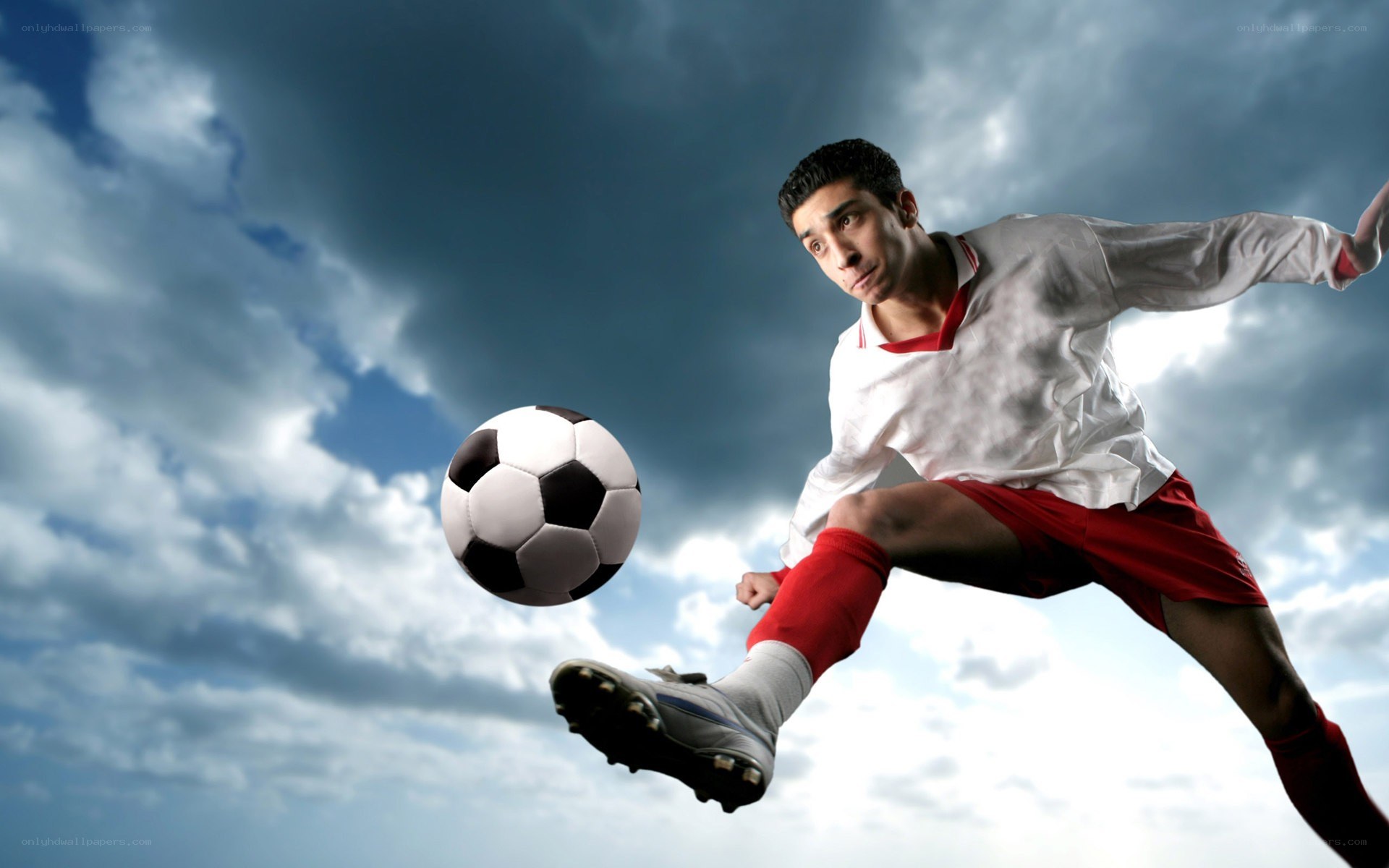 soccer player kicking ball