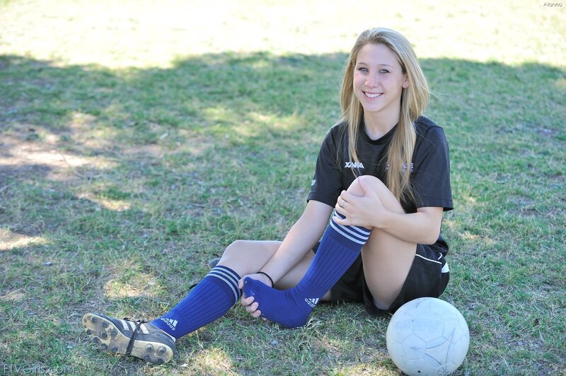 soccer player sitting on field