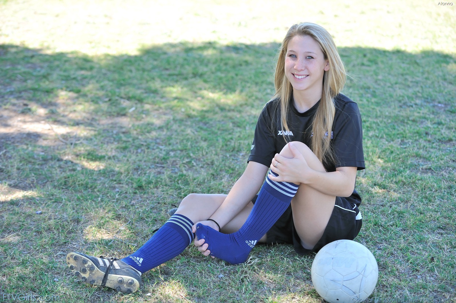 soccer player sitting on field