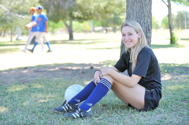 soccer player sitting on grass