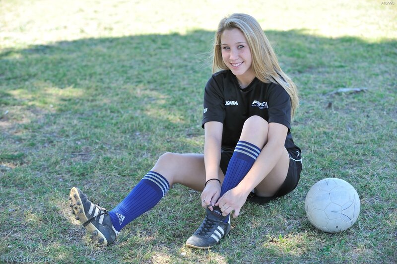 soccer player tying shoes