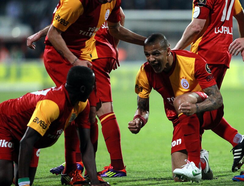 soccer players celebrating goal
