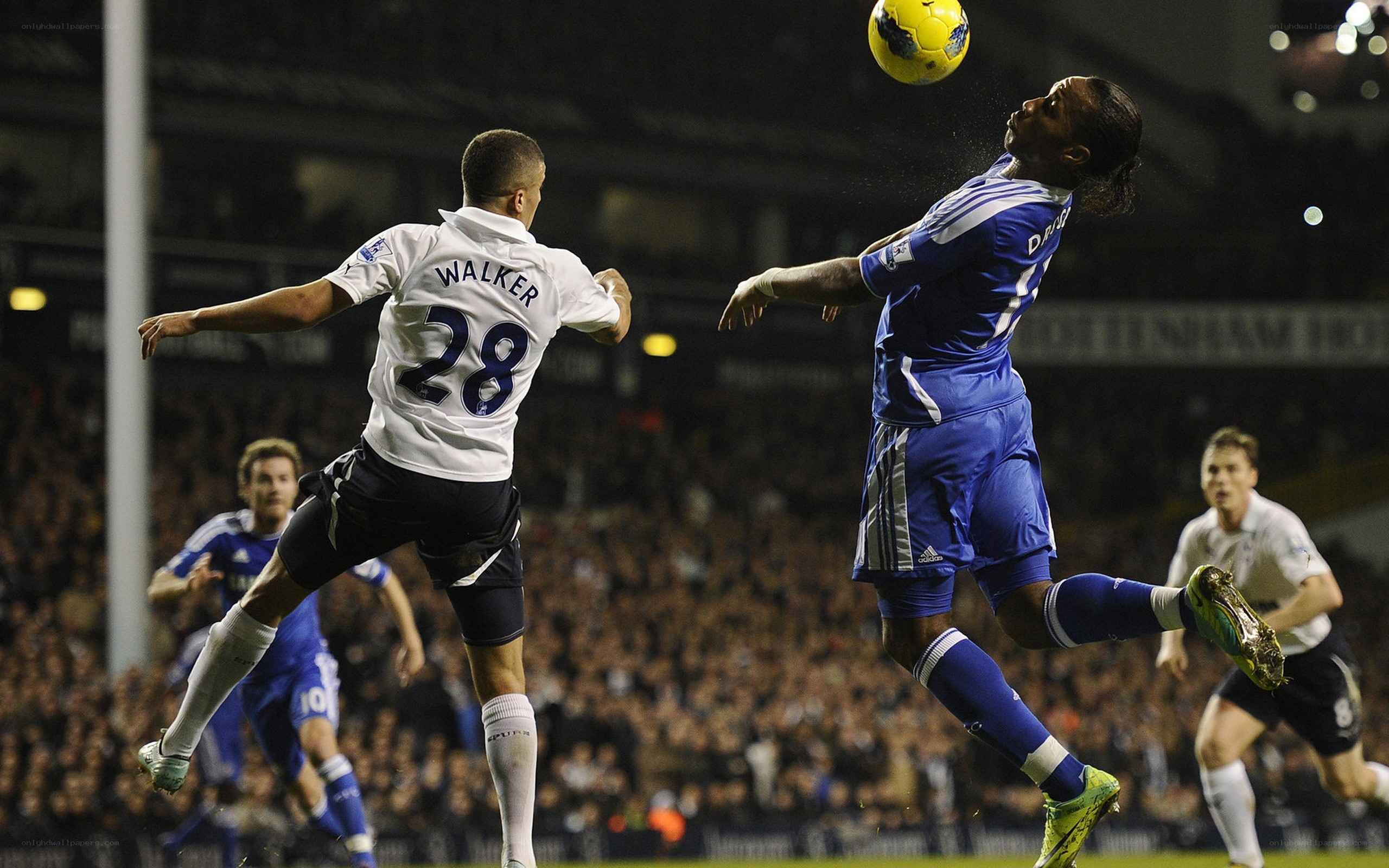 Soccer players jump for ball