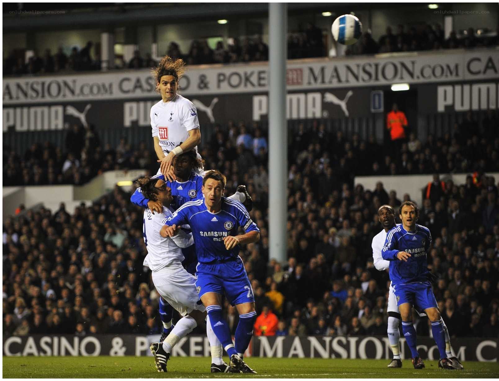 Soccer players jumping for ball