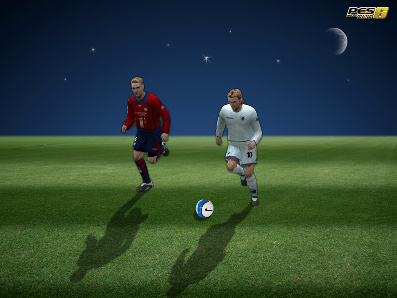 Soccer players on a field at night