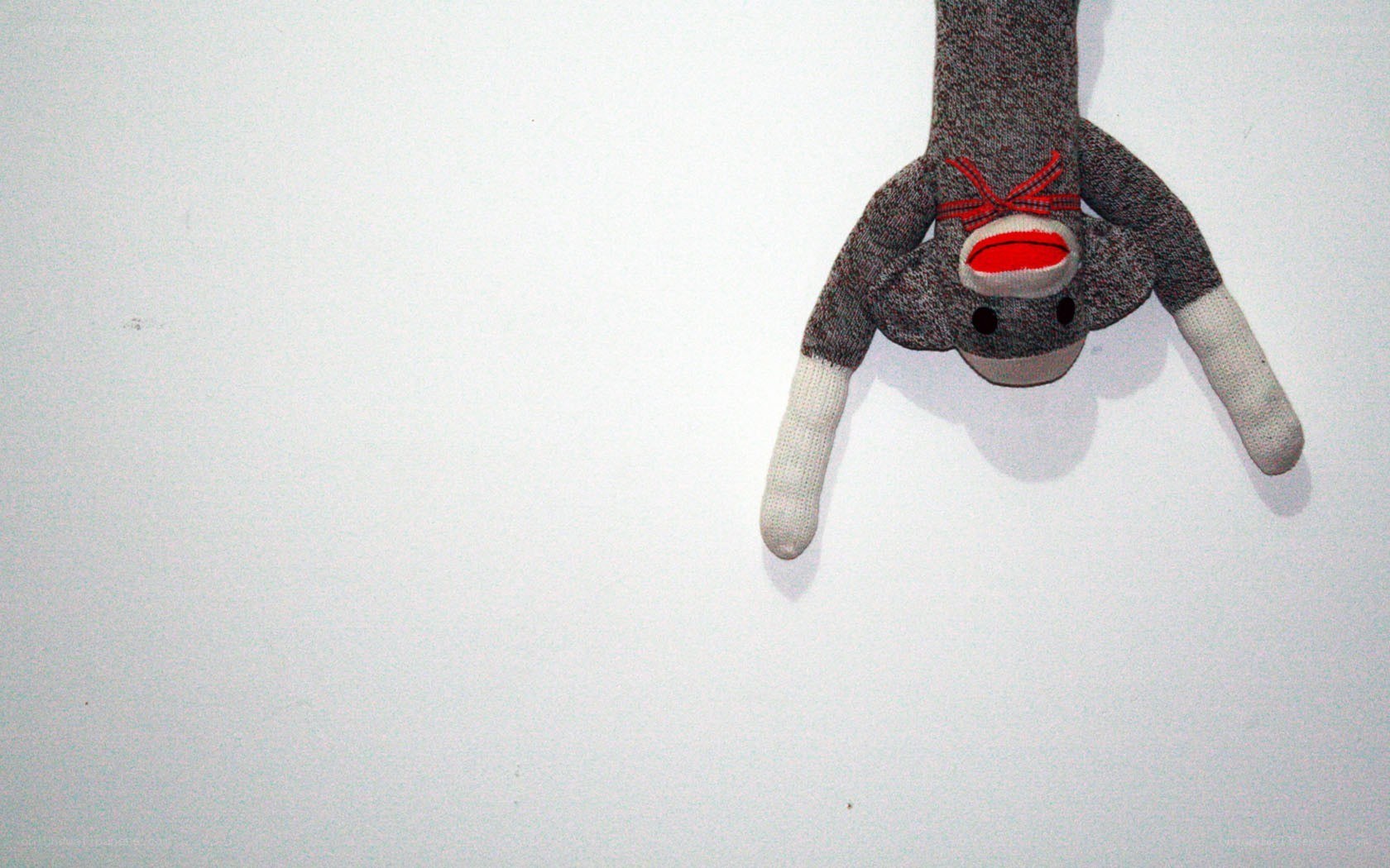 sock monkey hanging upside down