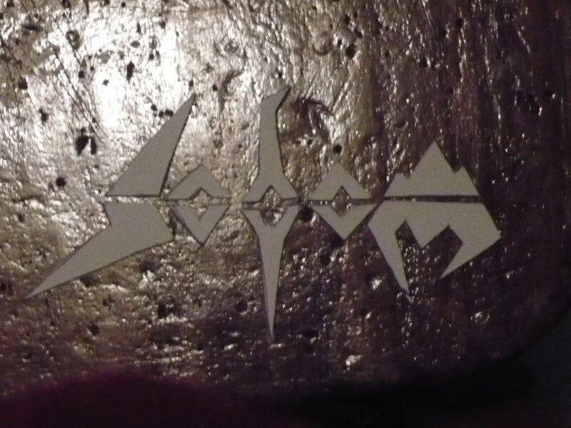 sodom logo on textured surface