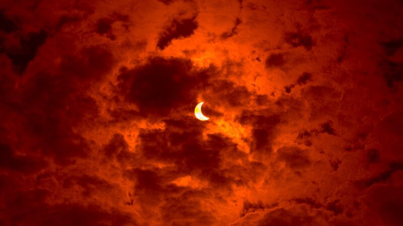 Solar Eclipse in Clouds — Red, Dramatic, Night