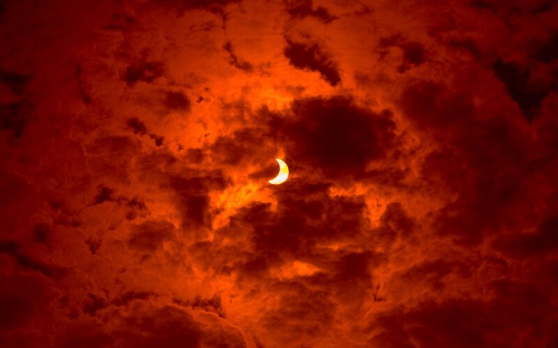 Solar Eclipse in Clouds — Red, Dramatic, Sunset, Photograph