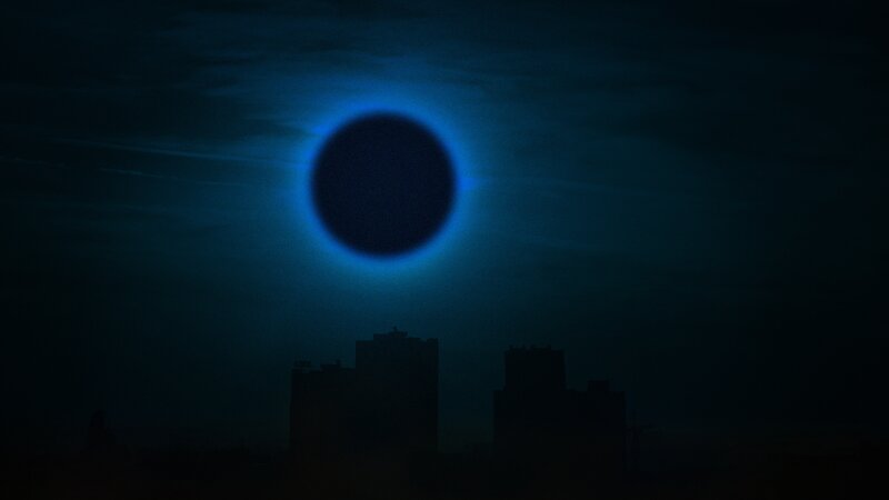 Solar Eclipse over City — Blue