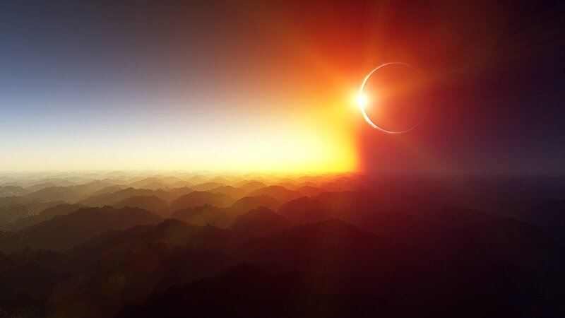 Solar eclipse over mountains