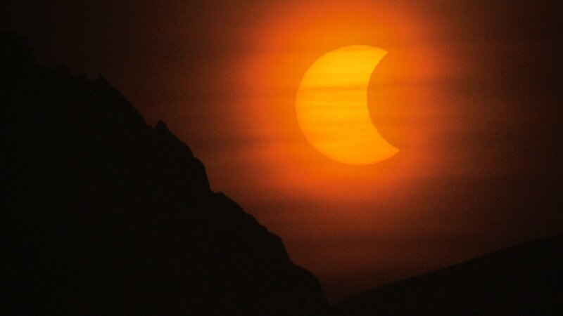 Solar Eclipse over Mountains — Orange