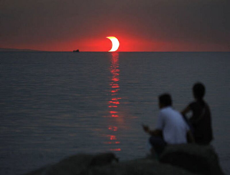Solar Eclipse over Ocean — Red