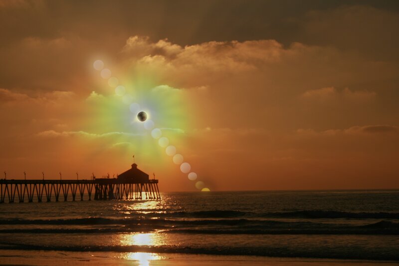 solar eclipse over pier