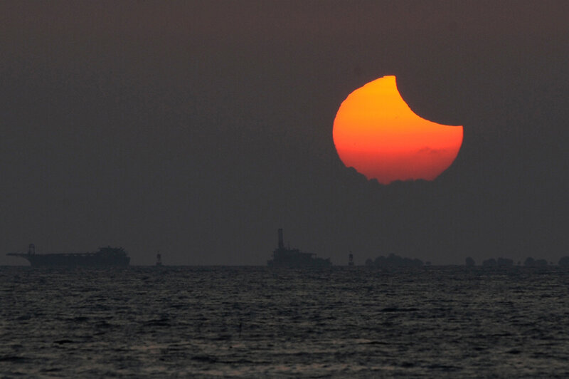 Solar Eclipse over Sea — Orange, Dramatic
