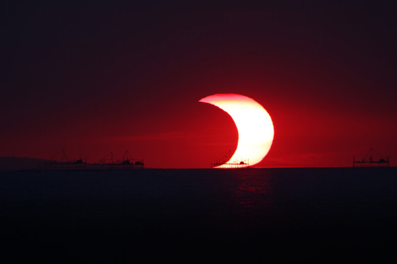 Solar Eclipse over Sea — Red