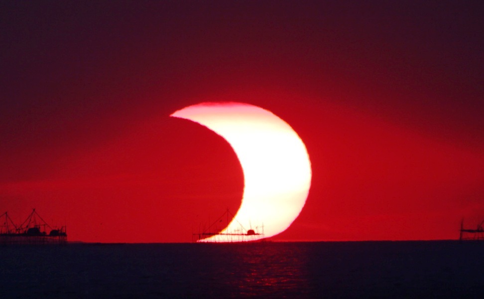solar eclipse over sea
