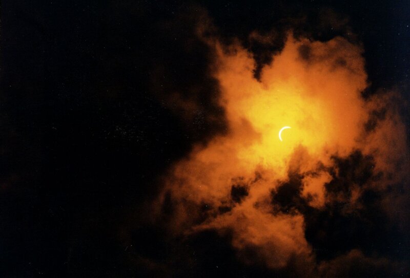 Solar Eclipse Through Clouds — Black